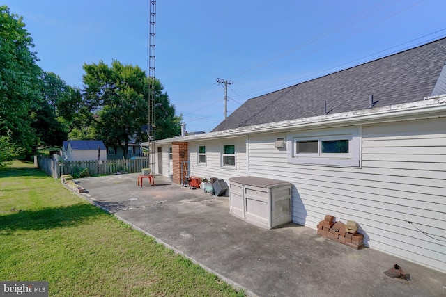 back of property featuring a patio area and a yard