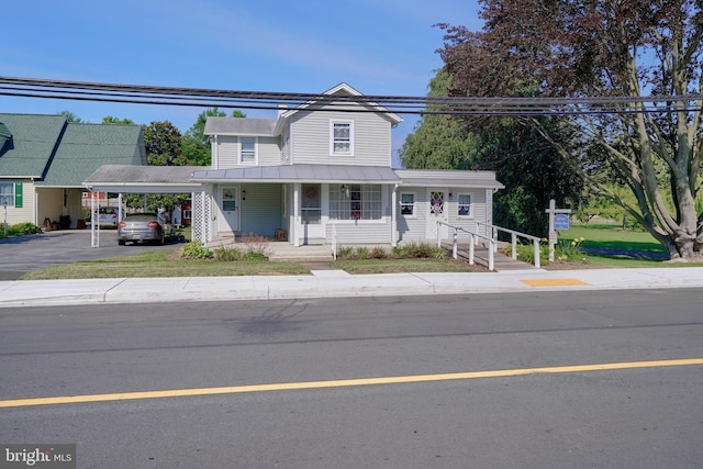 view of front of property with a porch and a carport