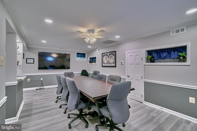 office space featuring crown molding, light hardwood / wood-style flooring, and ceiling fan