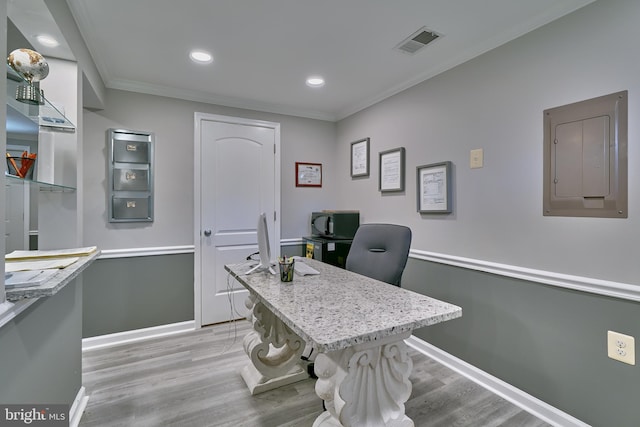 office space with electric panel, crown molding, and light hardwood / wood-style floors