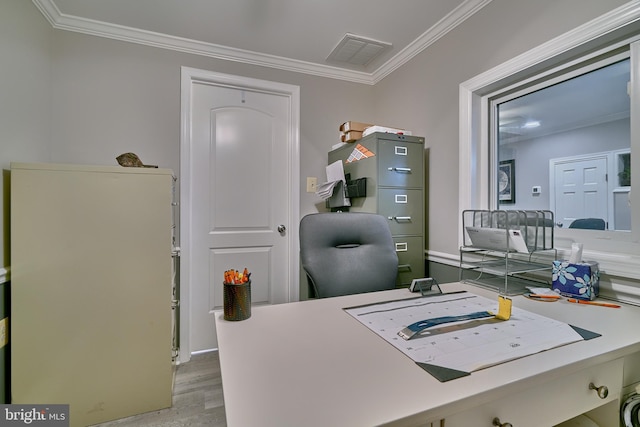 home office with crown molding and light wood-type flooring