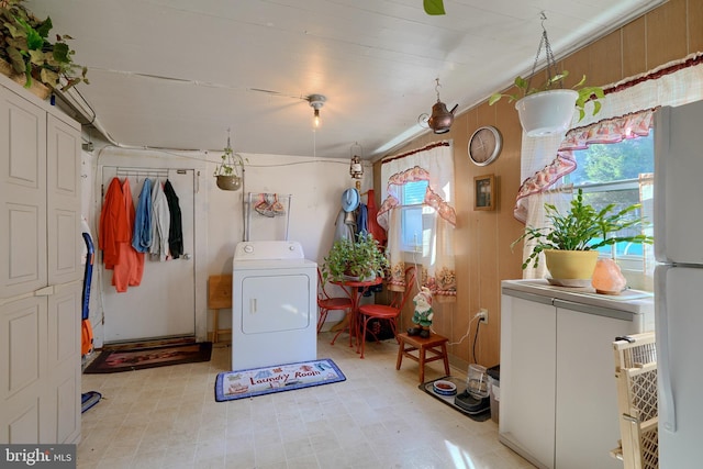 laundry room with washer / dryer and wooden walls