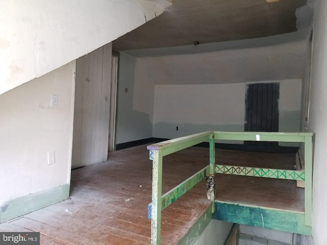 interior space featuring lofted ceiling and wood-type flooring