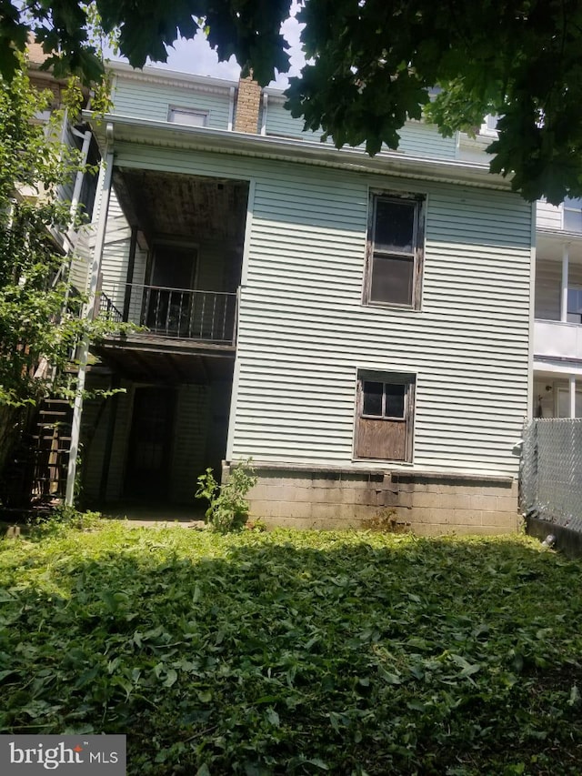 view of side of property with a balcony