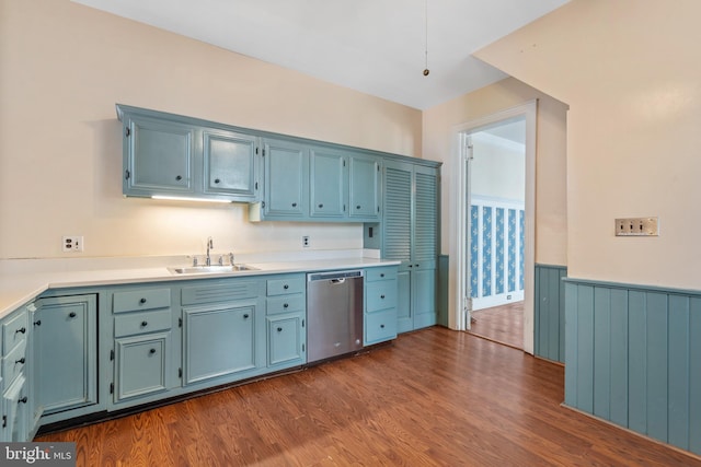 kitchen featuring dishwasher, hardwood / wood-style flooring, blue cabinets, and sink