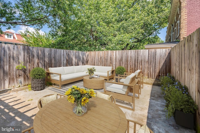 wooden terrace featuring an outdoor living space and a patio area