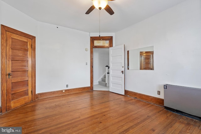 empty room featuring wood-type flooring and ceiling fan