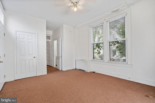 unfurnished bedroom with ceiling fan and light carpet