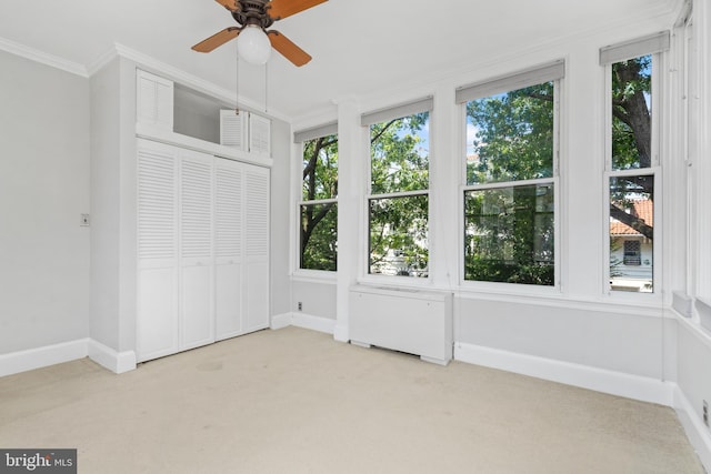 unfurnished bedroom with crown molding, multiple windows, and ceiling fan