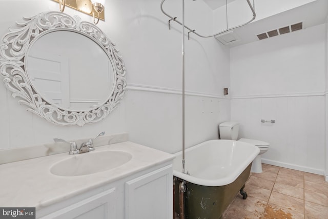 bathroom with vanity, toilet, and a bath