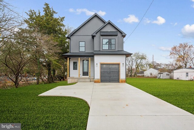 view of front of house with a front yard and a garage