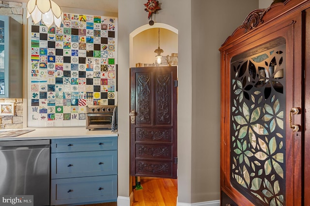 kitchen featuring light wood-type flooring, dishwasher, and tasteful backsplash