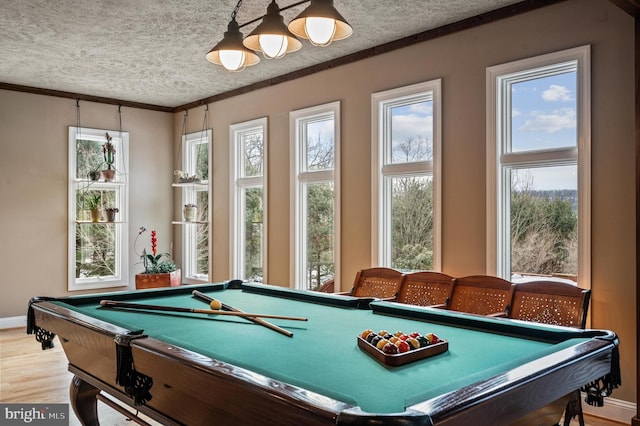 rec room with hardwood / wood-style flooring, pool table, ornamental molding, and a textured ceiling