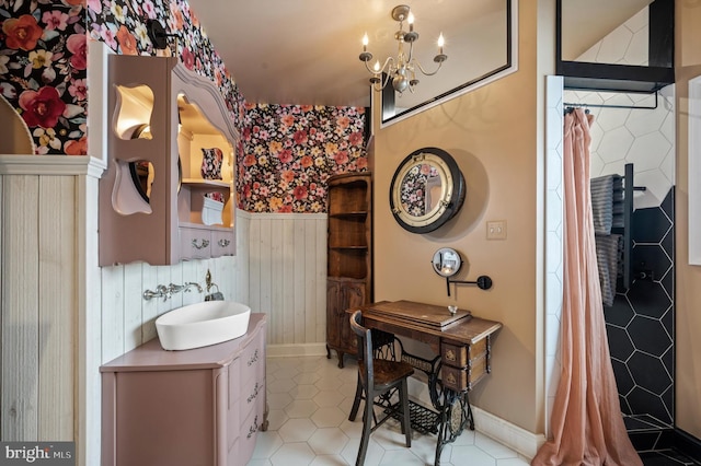 bathroom with a notable chandelier, tile patterned flooring, and vanity