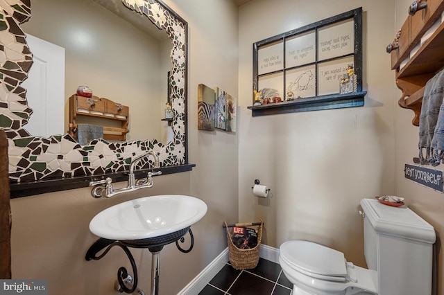 bathroom with toilet and tile patterned flooring