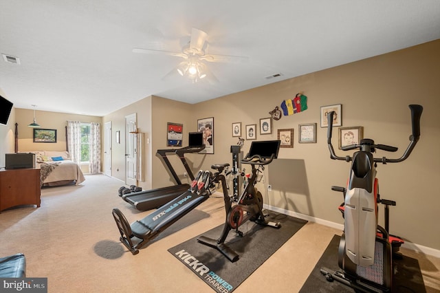 workout area with ceiling fan and carpet floors