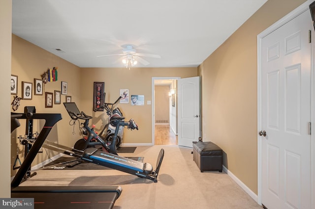 exercise room featuring ceiling fan and light carpet