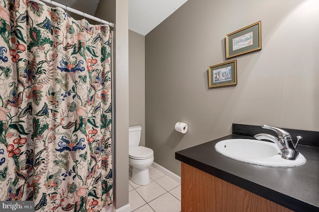 bathroom with toilet, tile patterned floors, and vanity