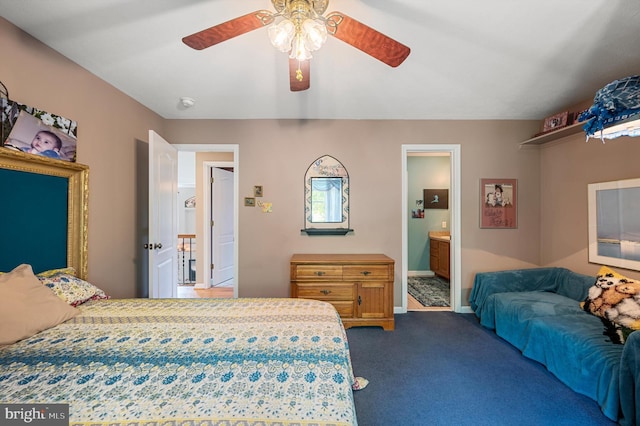 bedroom with connected bathroom, dark carpet, and ceiling fan