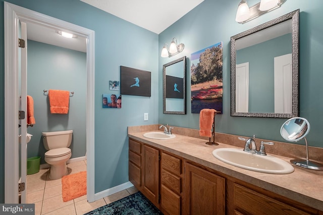 bathroom featuring vanity, tile patterned floors, and toilet