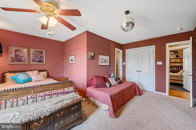 bedroom featuring ceiling fan, light colored carpet, and a closet