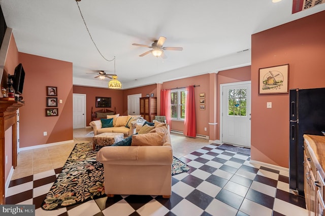 living room featuring ceiling fan and baseboard heating