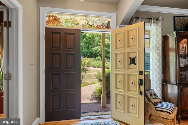 foyer featuring crown molding