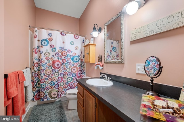 bathroom featuring toilet, vanity, tile patterned floors, and curtained shower