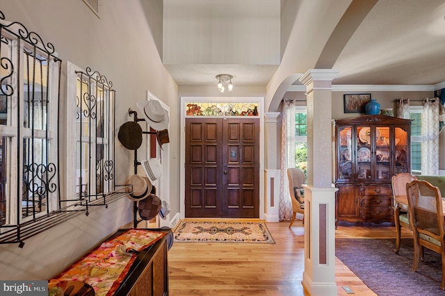 entryway featuring ornate columns and hardwood / wood-style floors