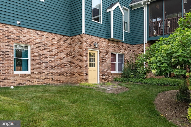 entrance to property featuring a lawn