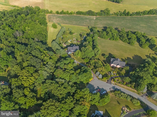 birds eye view of property with a rural view