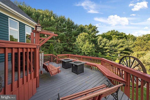 wooden deck with an outdoor fire pit