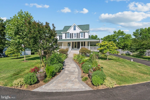 view of front of property with covered porch and a front yard