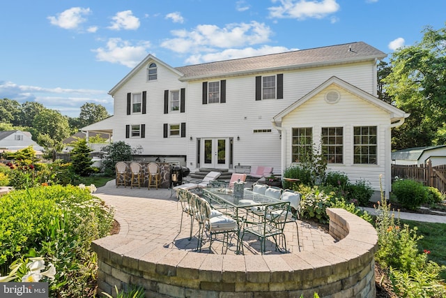 back of house with french doors, an outdoor bar, and a patio area