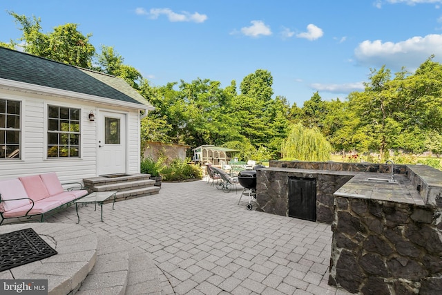 view of patio with sink and area for grilling