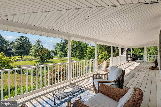 wooden terrace with a lawn