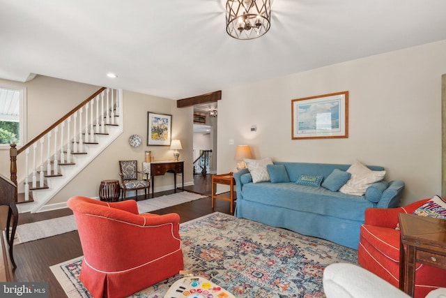 living room with baseboards, stairs, and wood finished floors