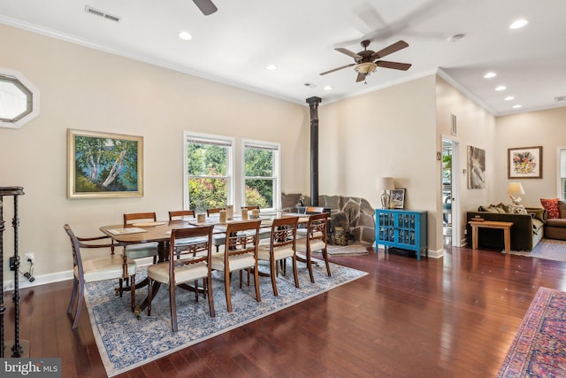 dining space with visible vents, crown molding, baseboards, ceiling fan, and hardwood / wood-style floors