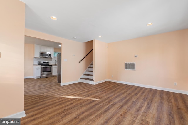 unfurnished living room featuring hardwood / wood-style floors