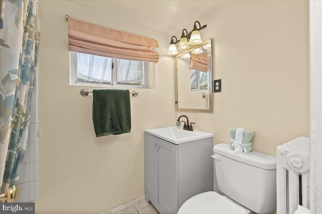 bathroom featuring toilet, tile patterned floors, vanity, and curtained shower