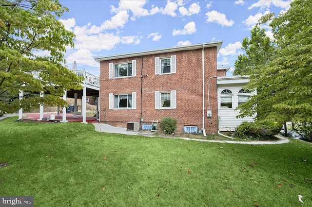 back of property featuring a patio area, a yard, and central AC