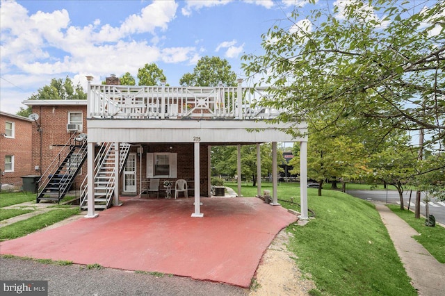 exterior space featuring a yard, a deck, a patio, and cooling unit