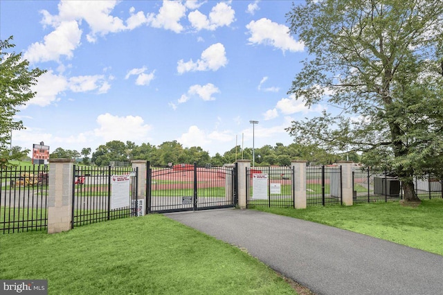 view of gate featuring a yard