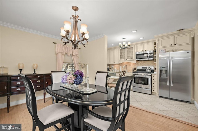 dining space featuring light tile patterned floors, a chandelier, and ornamental molding