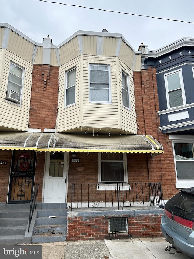 view of front facade with a porch and cooling unit