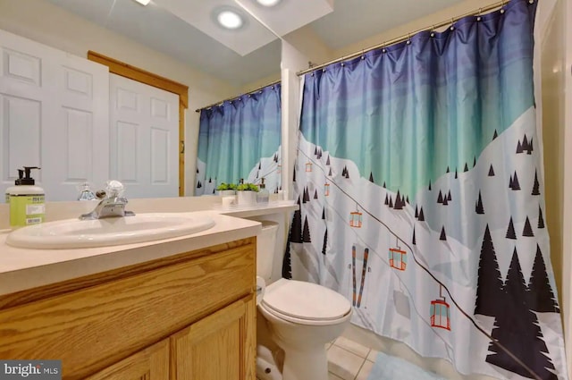 bathroom featuring tile patterned flooring, vanity, a shower with shower curtain, and toilet