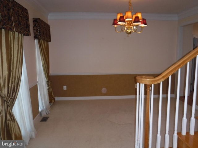 interior space with carpet flooring, ornamental molding, and a chandelier