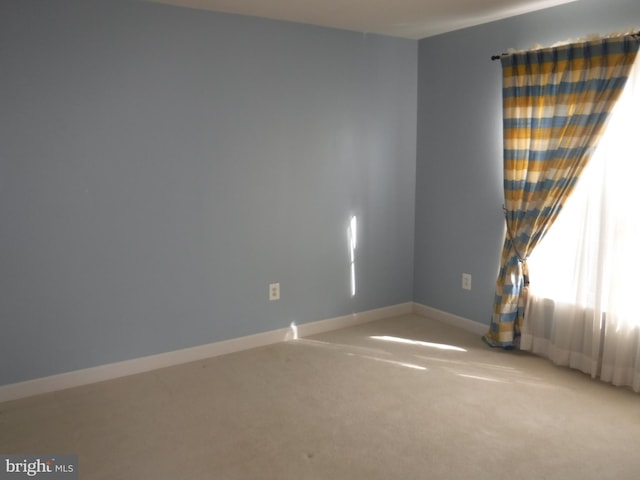 empty room featuring light carpet