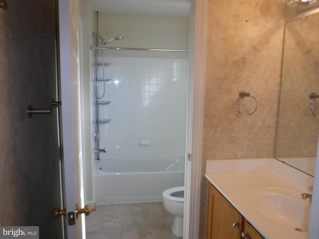 full bathroom with washtub / shower combination, vanity, toilet, and tile patterned flooring