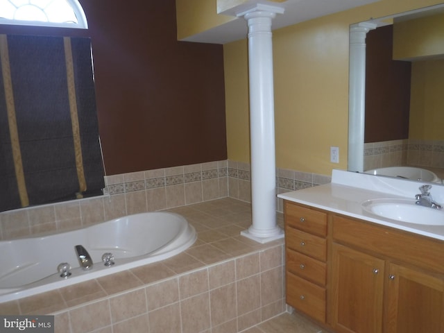 bathroom with tiled tub and vanity